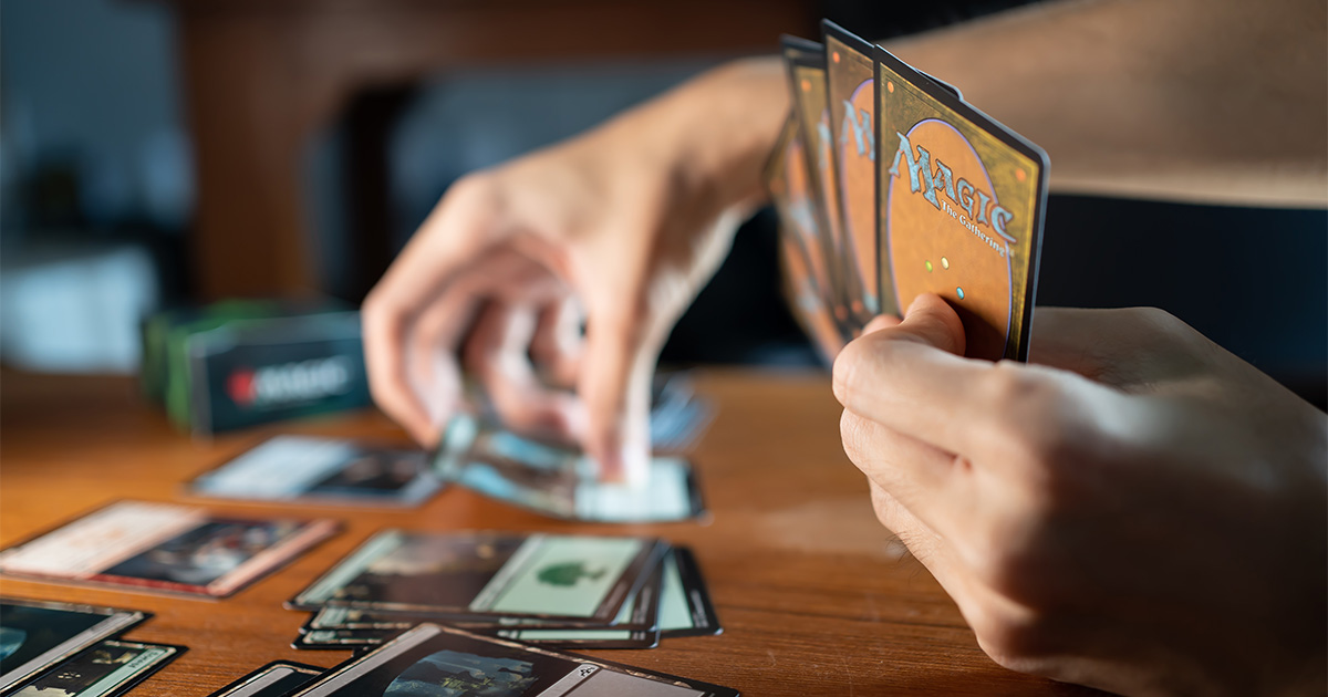 Person learning how to play commander magic the gathering